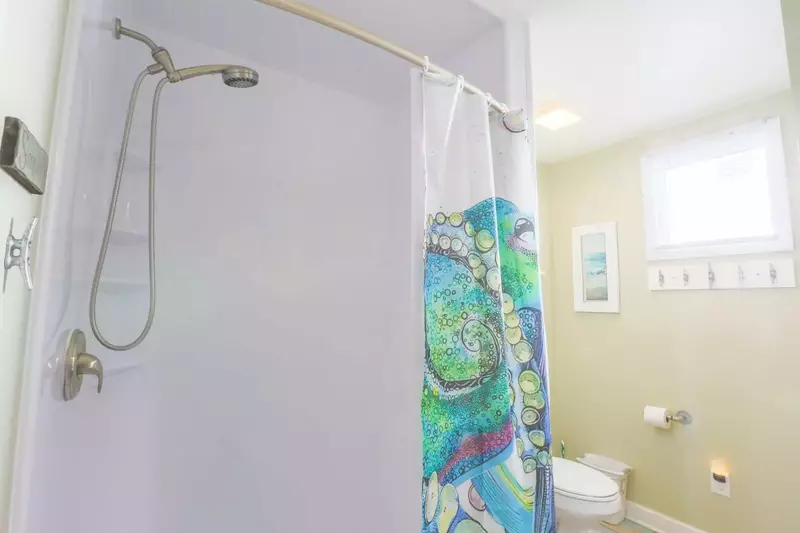 The adjustable shower head is perfect for hosing down your kids after a trip to the beach.
