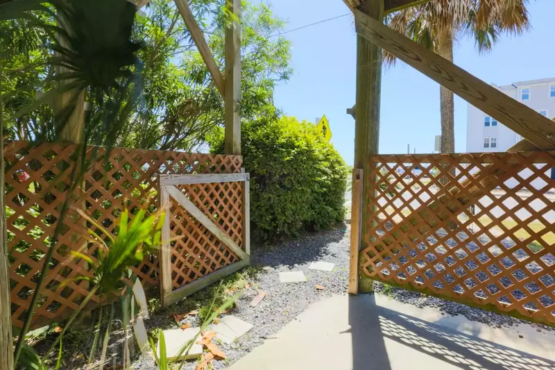 This walkway beneath the house leads to the public beach access point.