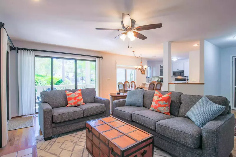 There are two sets of sliding glass doors in the living room -- one to the screened porch and one to the deck.