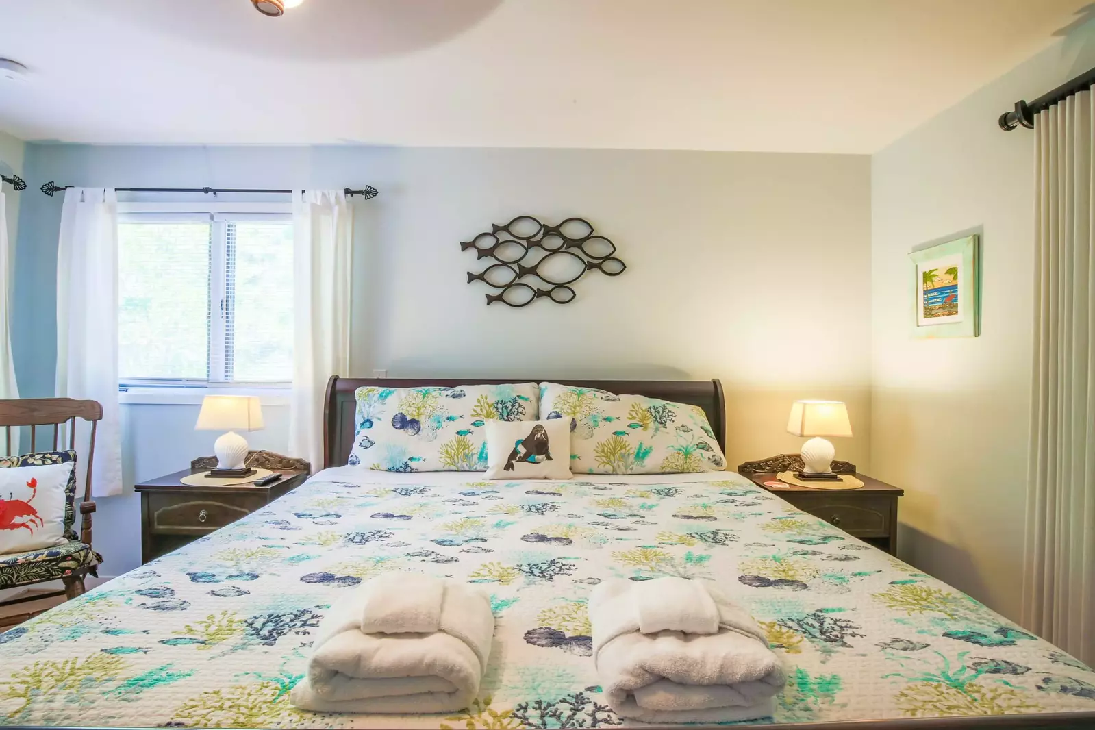The master suite features a king bed and night stands with reading lamps.