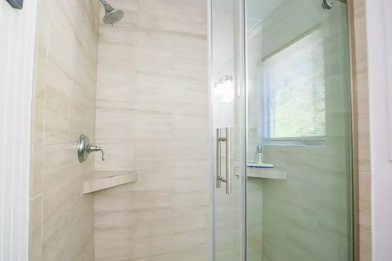 The master bathroom also features a beautifully tiled, walk-in shower.