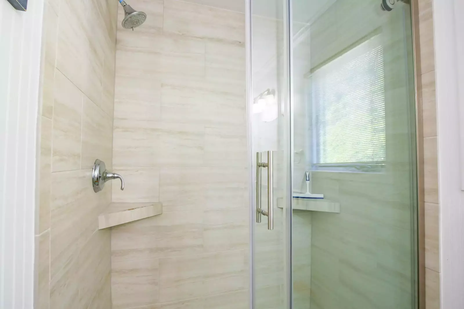 The master bathroom also features a beautifully tiled, walk-in shower.