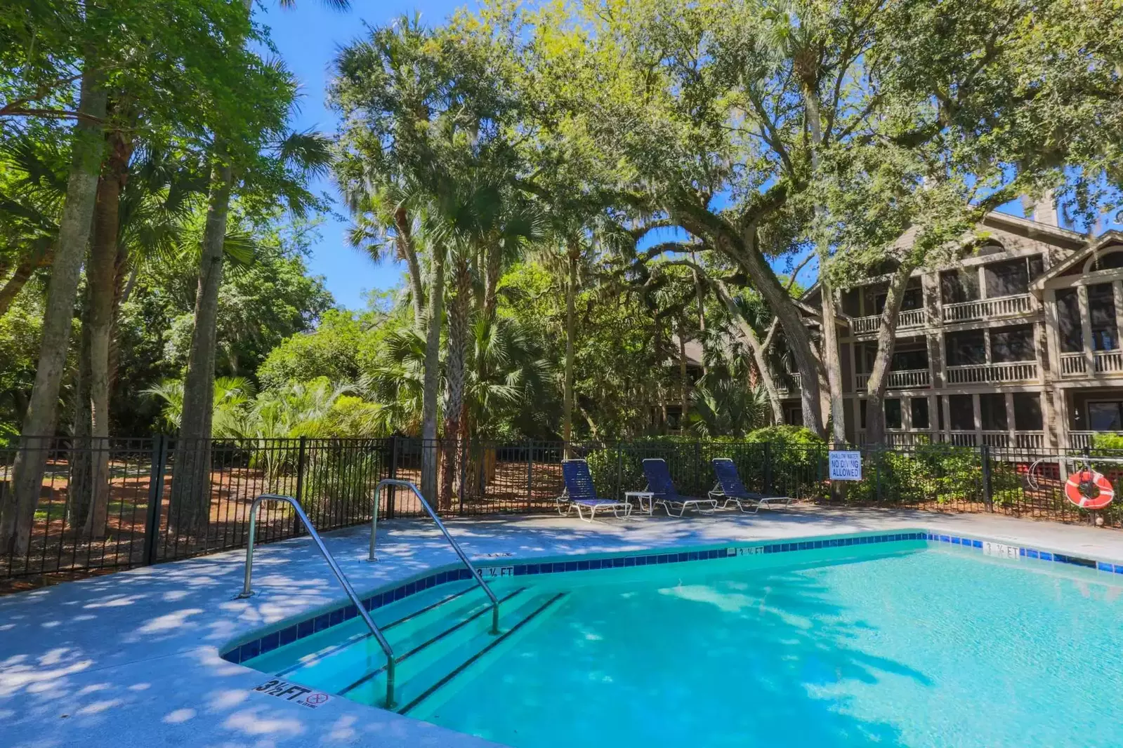 The community pool is surrounded by beautiful Lowcountry trees.