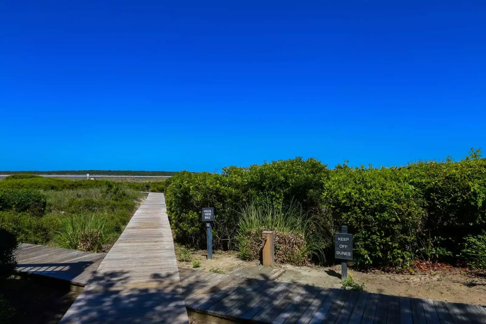 You can access the beach using any of the numbered Beach Boardwalks. Boardwalk #9 is a 15 to 20 min walk.