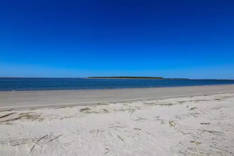 This quiet, white sandy beach could be all yours!