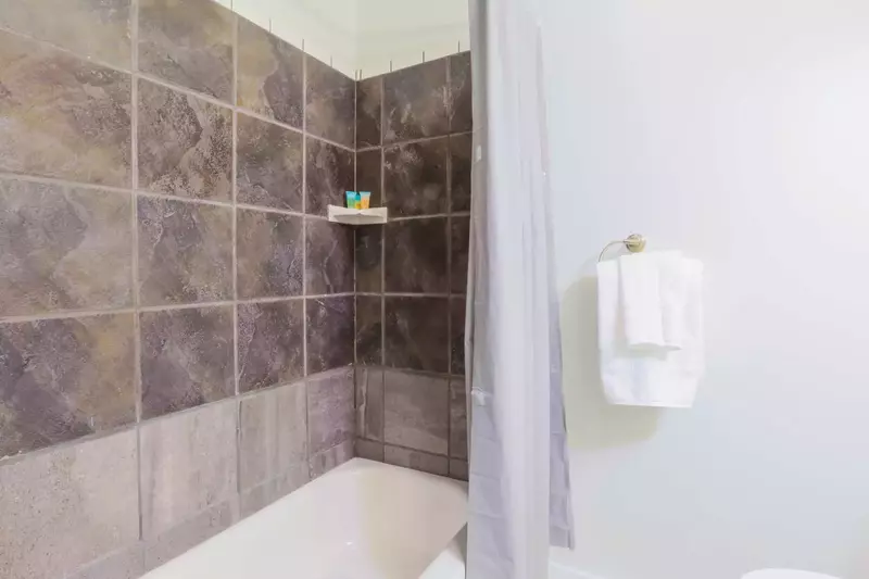 This hallway bath also has a shower/tub combo.