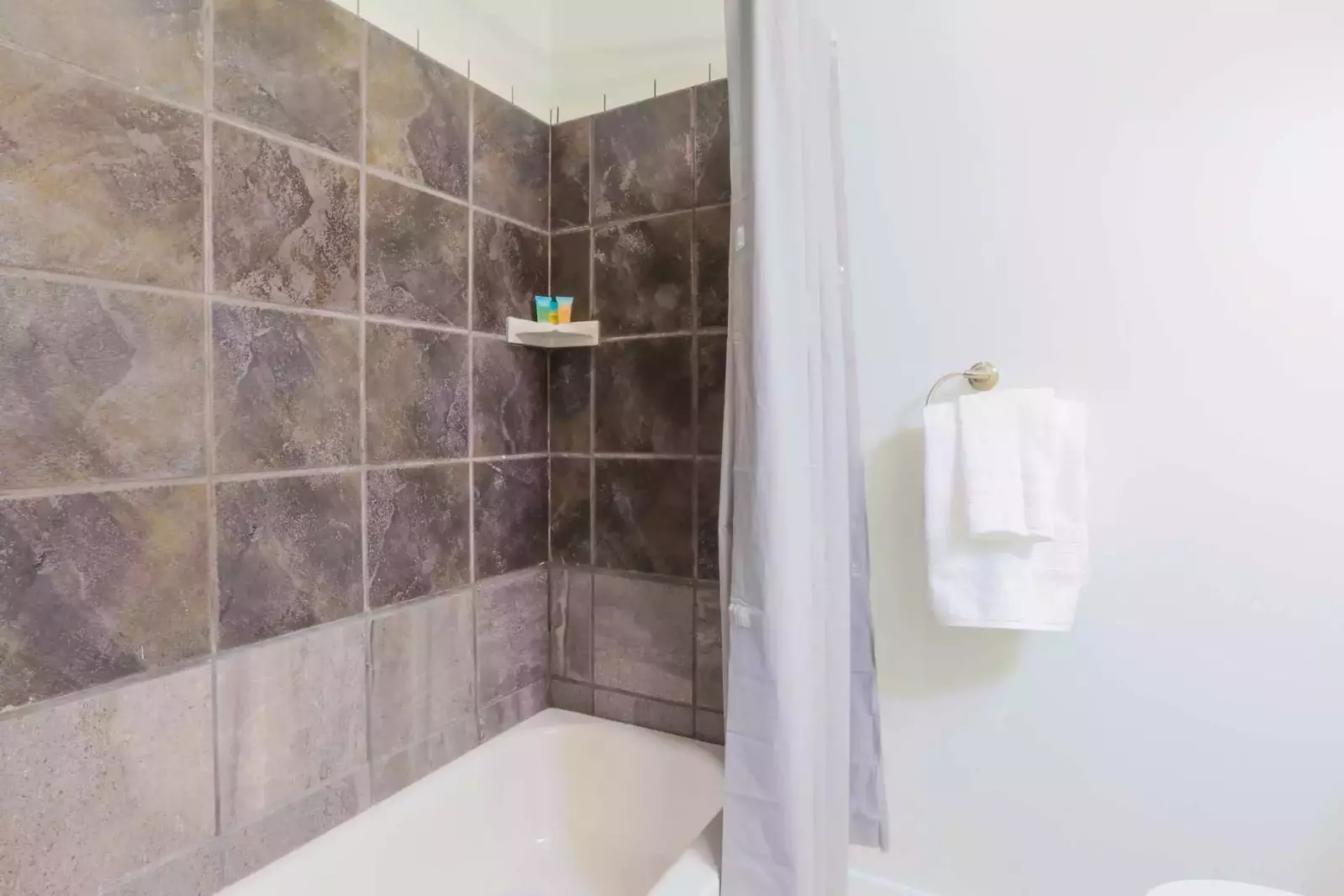 This hallway bath also has a shower/tub combo.