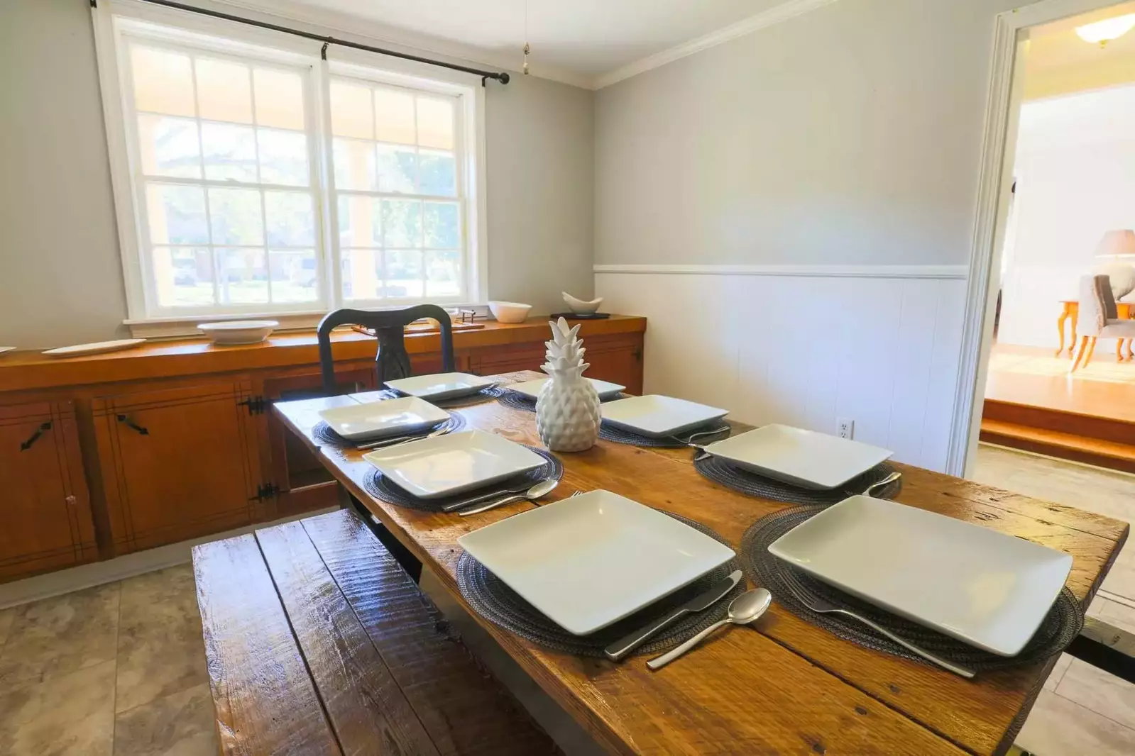 The dining room connects the living room, entryway, kitchen and living room portions of the house.