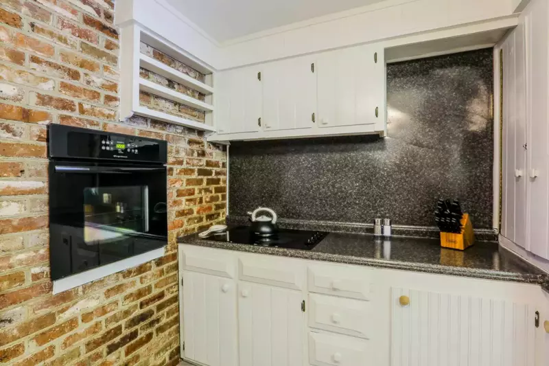 The kitchen features an oven, separate cooktop and lots of cabinetry.