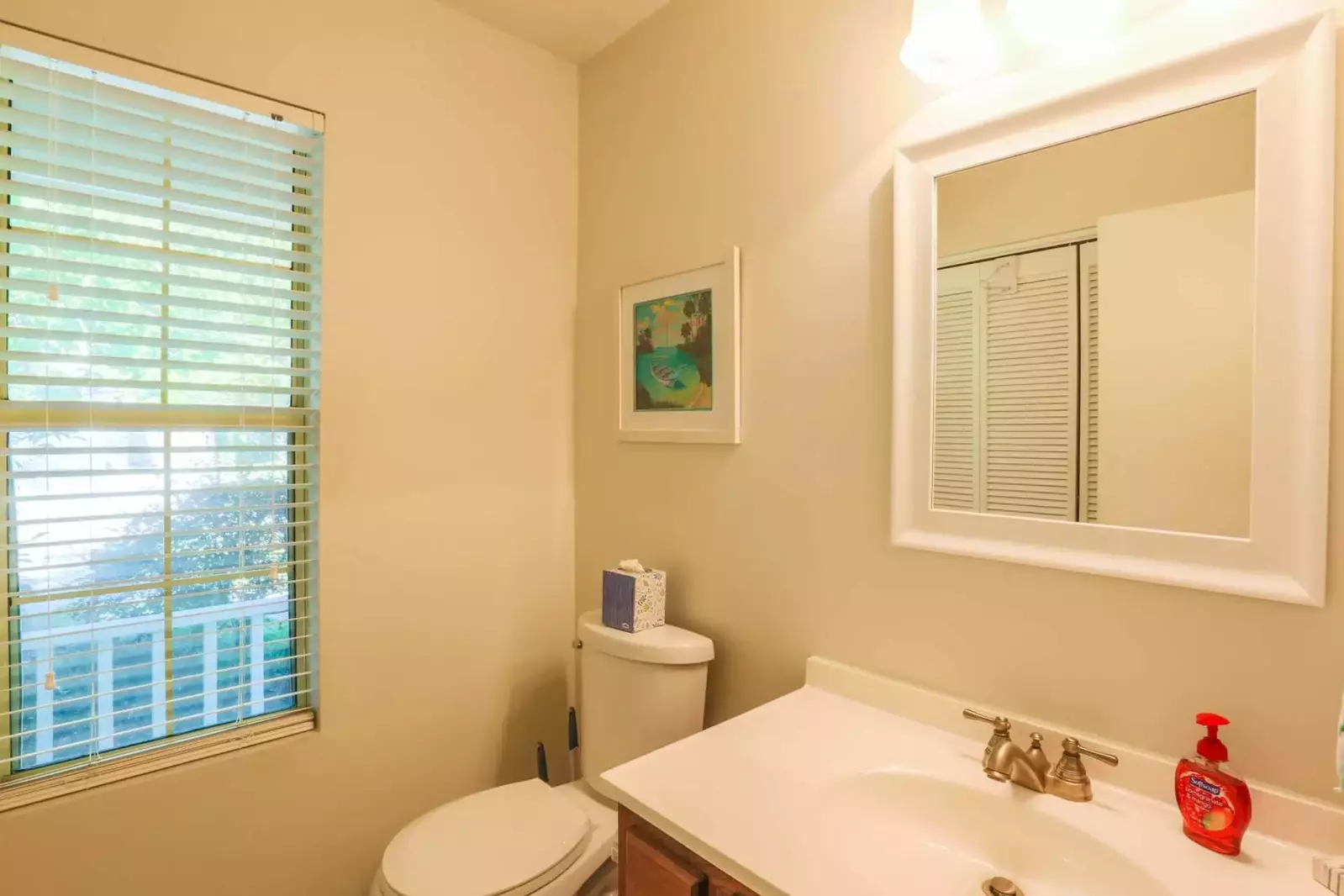 There is a full size washing machine and dryer in this half bathroom on the ground floor.