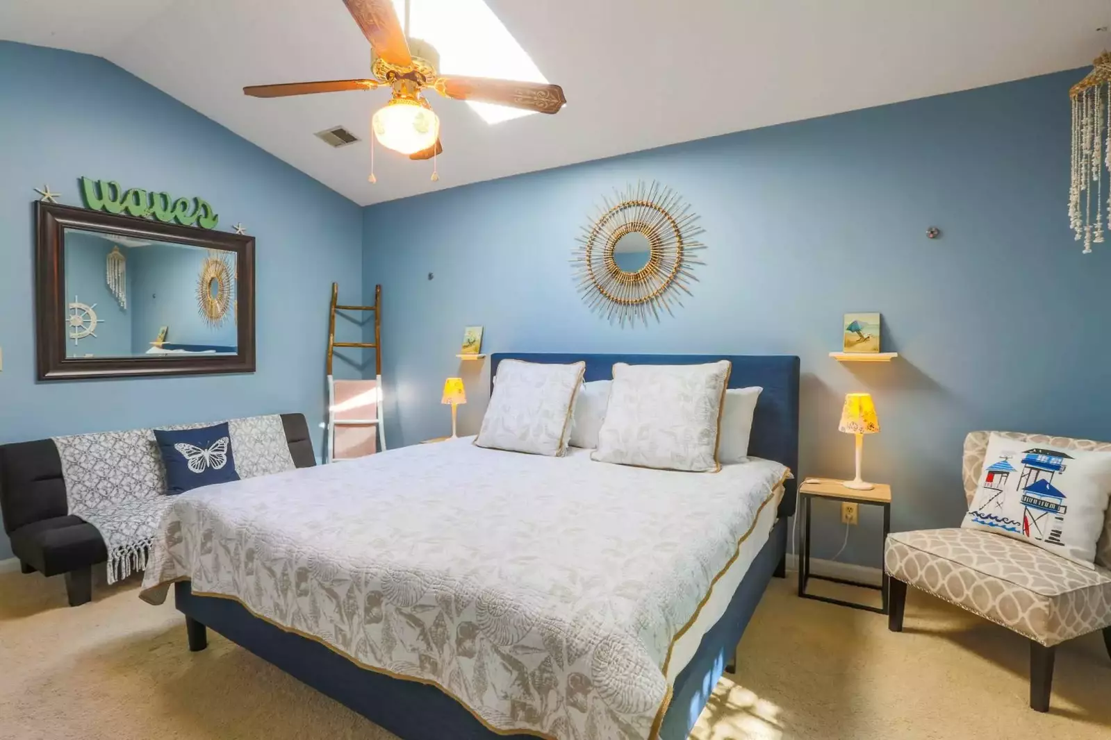 The master bedroom, which is located on the ground floor, also has a ceiling fan and a seating area.