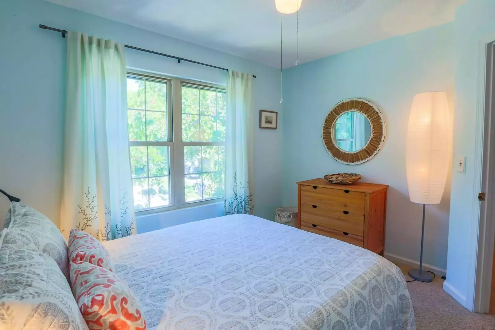 At the top of the stairs on the second floor, you'll find this soothing guest bedroom.