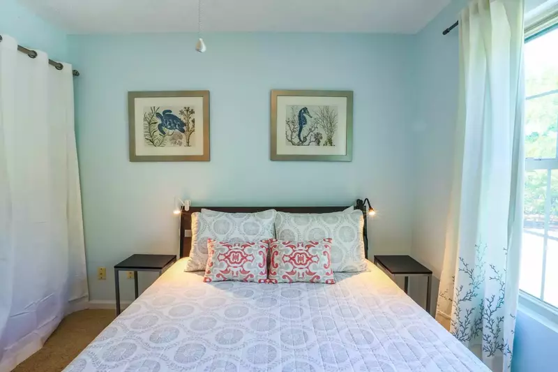 This guest bedroom has a queen size bed, night stands and reading lamps.