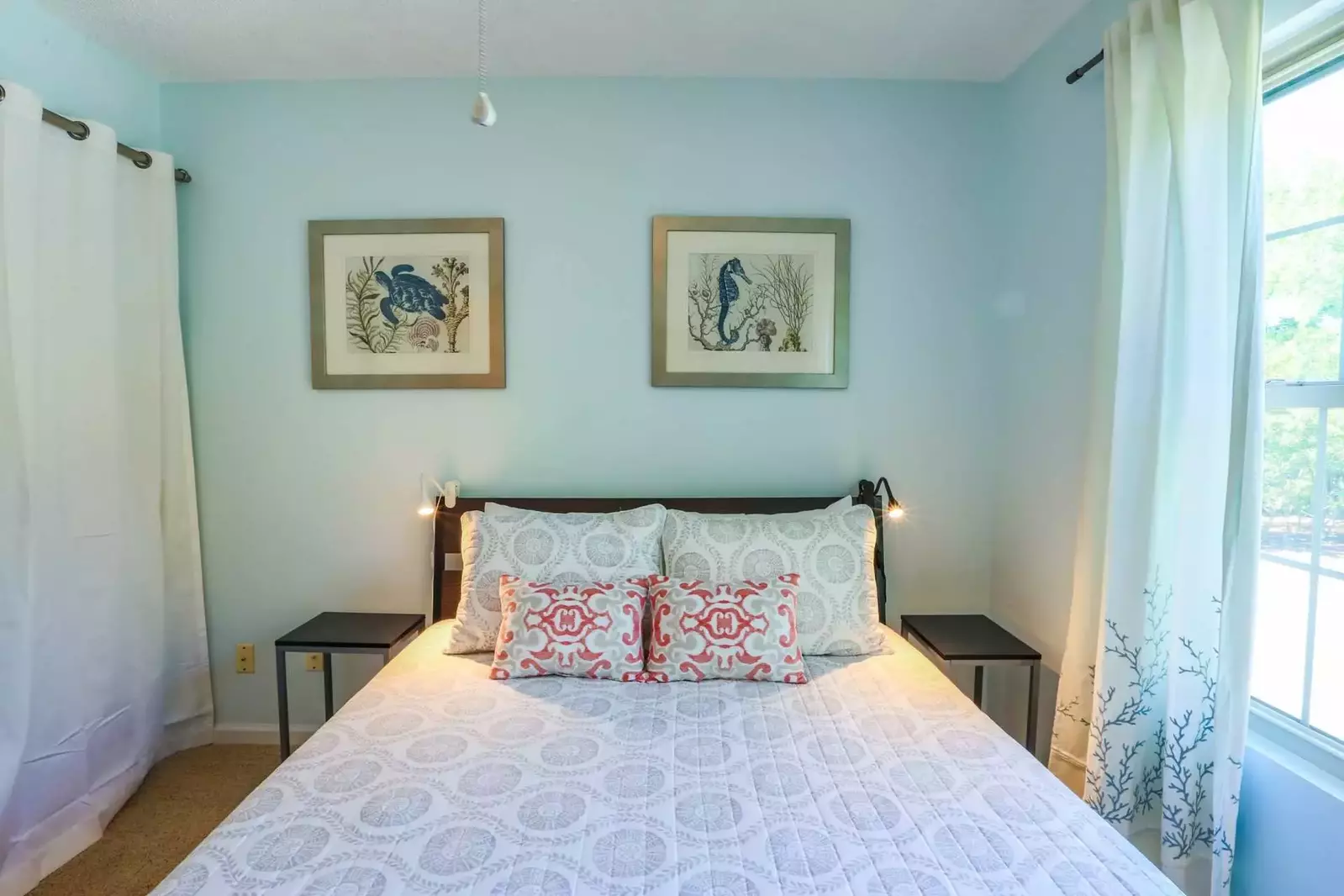 This guest bedroom has a queen size bed, night stands and reading lamps.