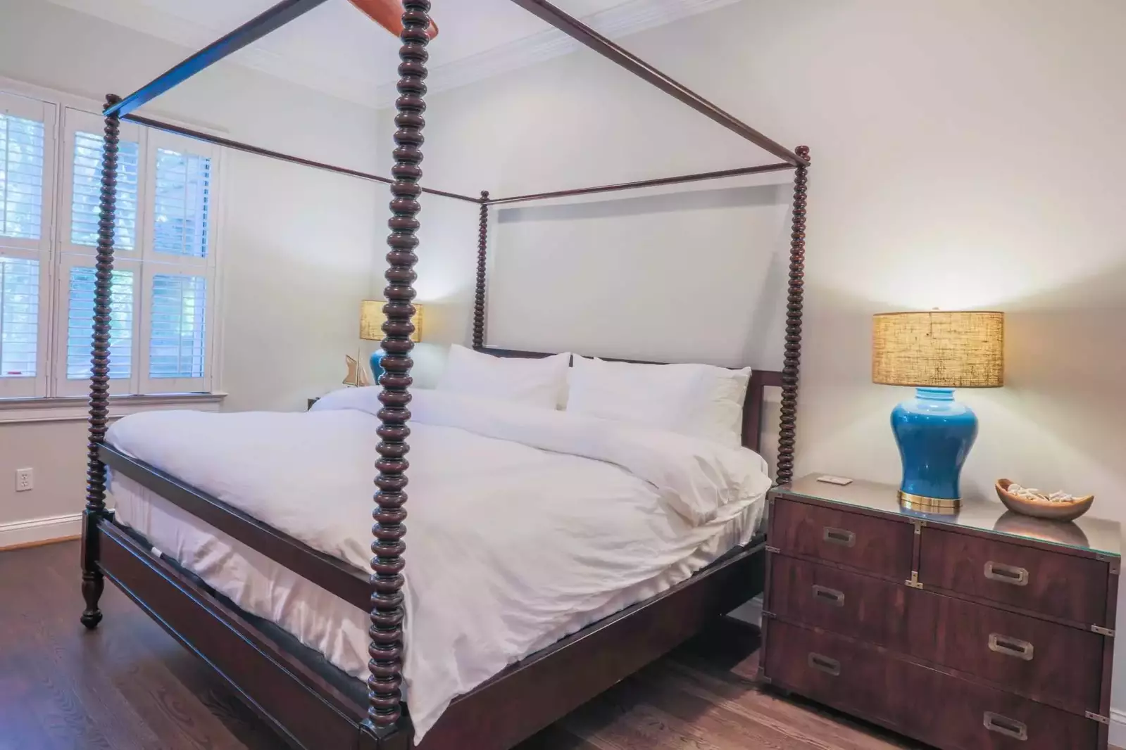 The master suite, which is located on the home's ground floor, has a king bed and hardwood floors.