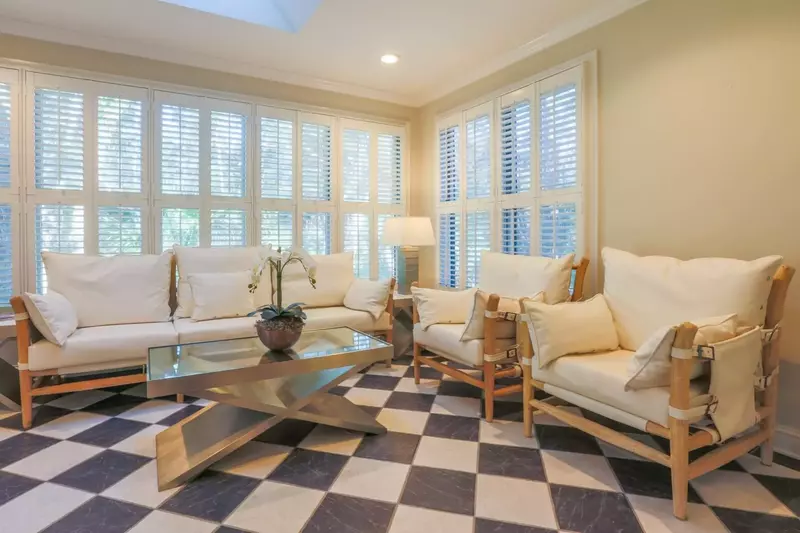 You'll love the sunroom's wall-to-wall windows and black & white marble flooring.