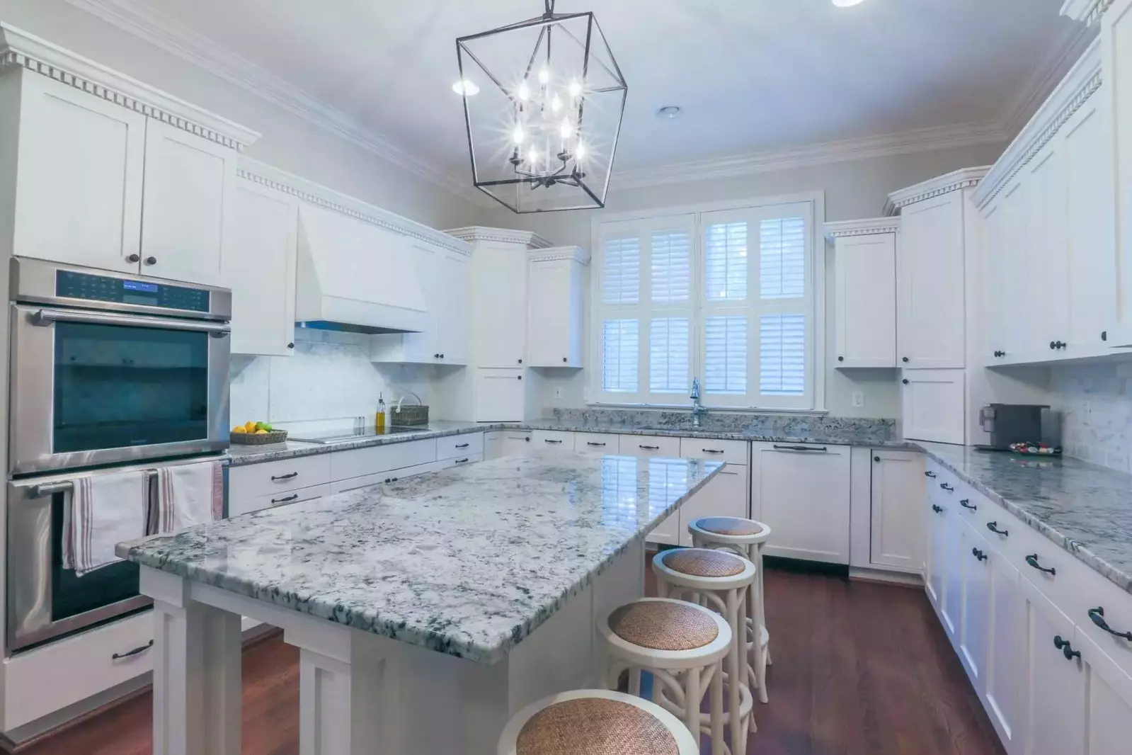The kitchen features a double oven, cooktop, dishwasher and refrigerator.
