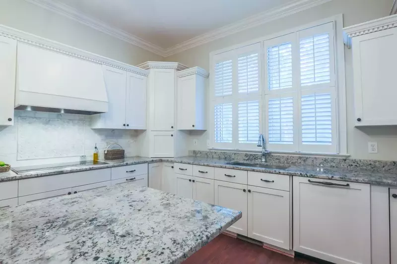 You'll love the kitchen's granite countertops and tiled backsplash.