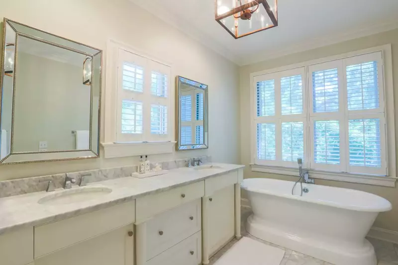 The pristine master bathroom has his & her vanities and a deep soaking tub.