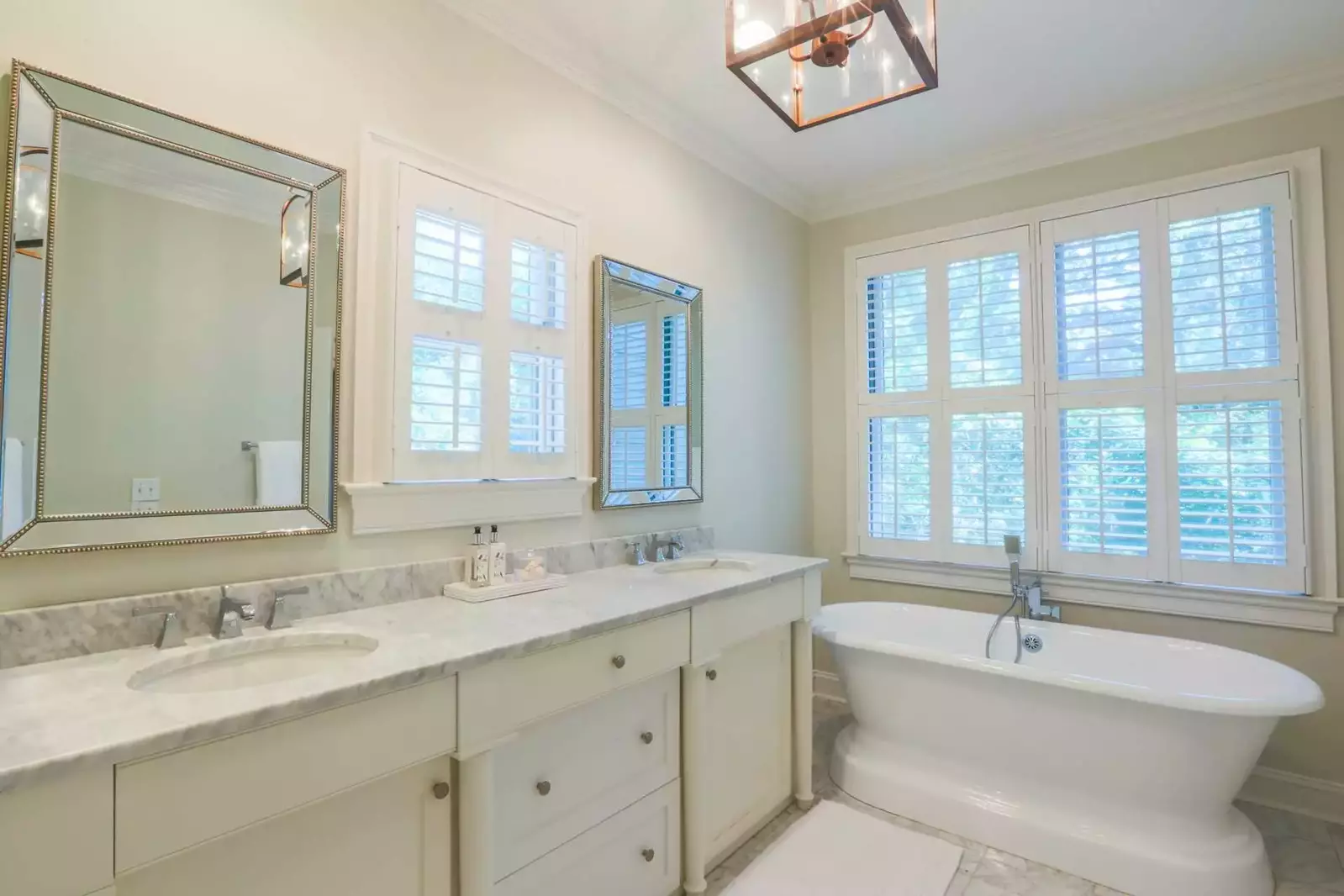 The pristine master bathroom has his & her vanities and a deep soaking tub.