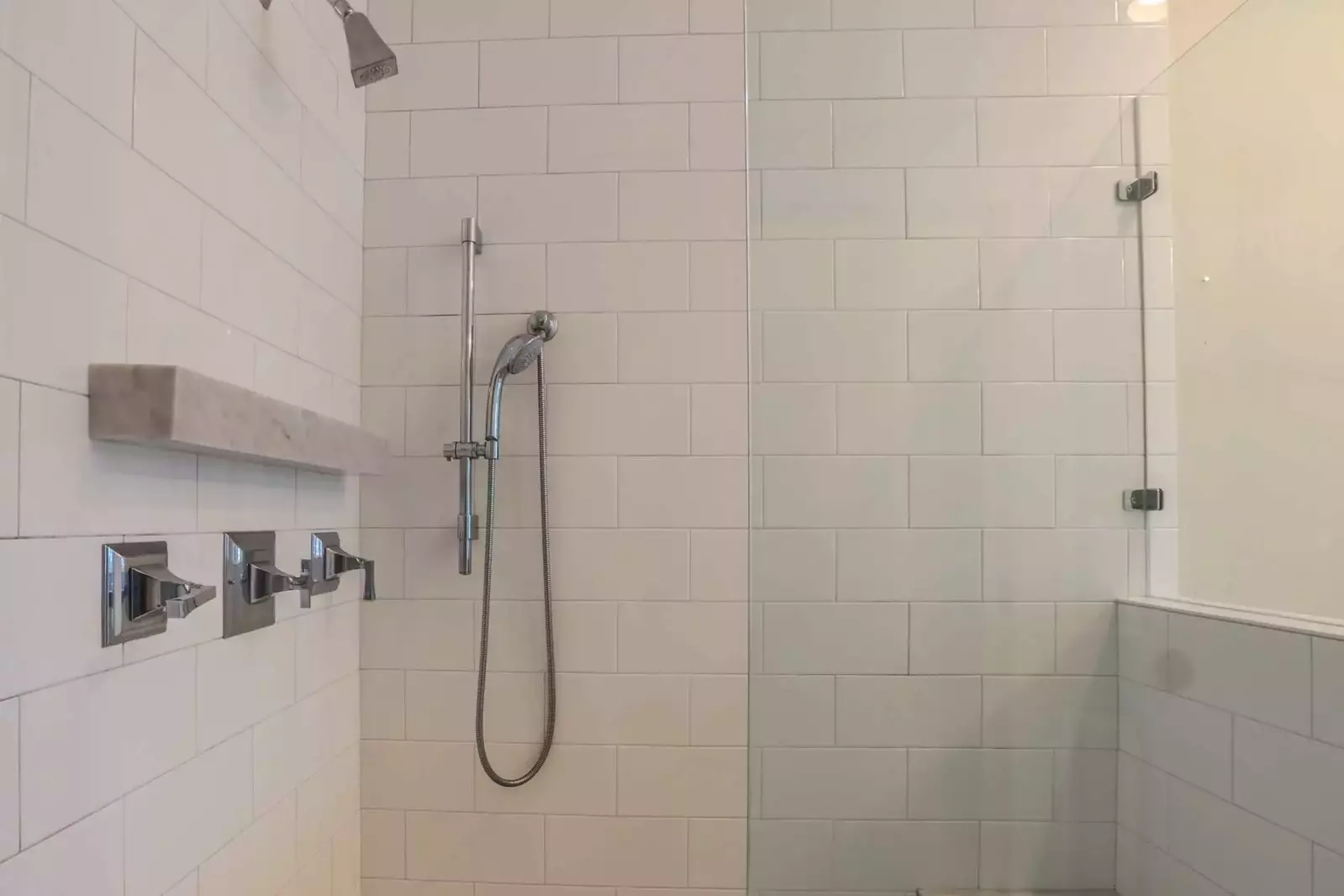 The master bathroom also features a walk-in shower with overhead and handheld sprayer.