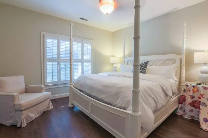 This guest bedroom, located on the home's second floor, features a king bed and nightstands with reading lamps.