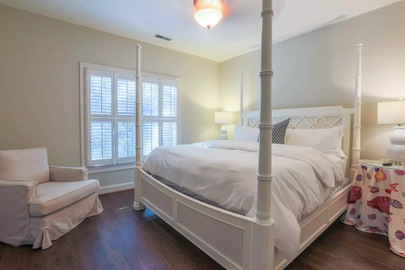 This guest bedroom, located on the home's second floor, features a king bed and nightstands with reading lamps.
