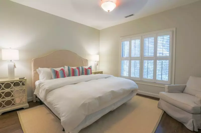This guest bedroom features a king bed flanked by two nightstands with reading lamps.