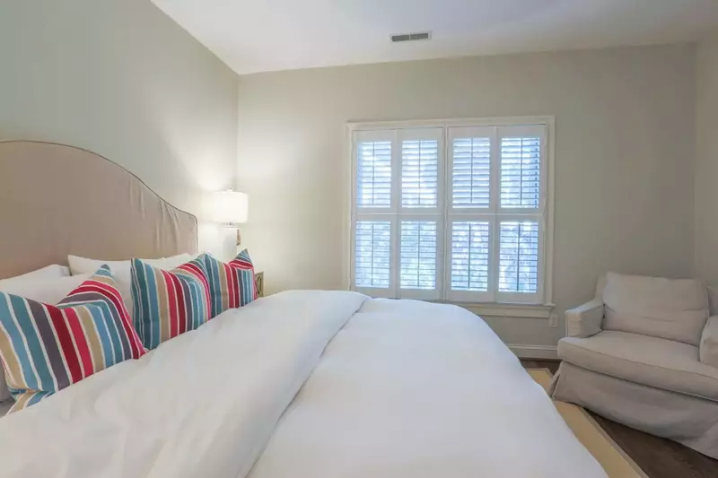 This bedroom is located on the home's second floor and looks out onto the back of the house.