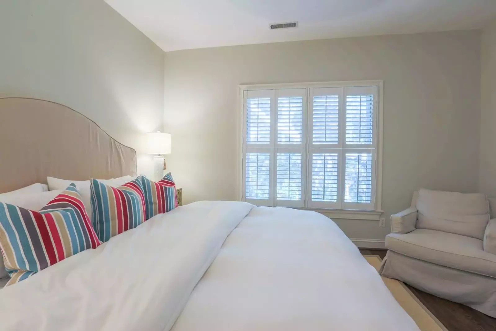 This bedroom is located on the home's second floor and looks out onto the back of the house.