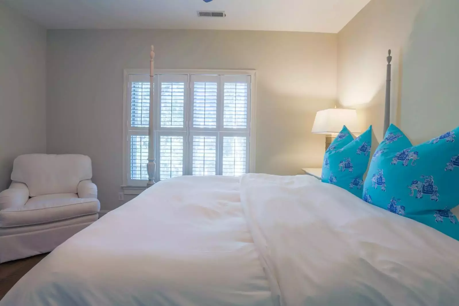 This bedroom receives lovely natural light with views out the back of the home.