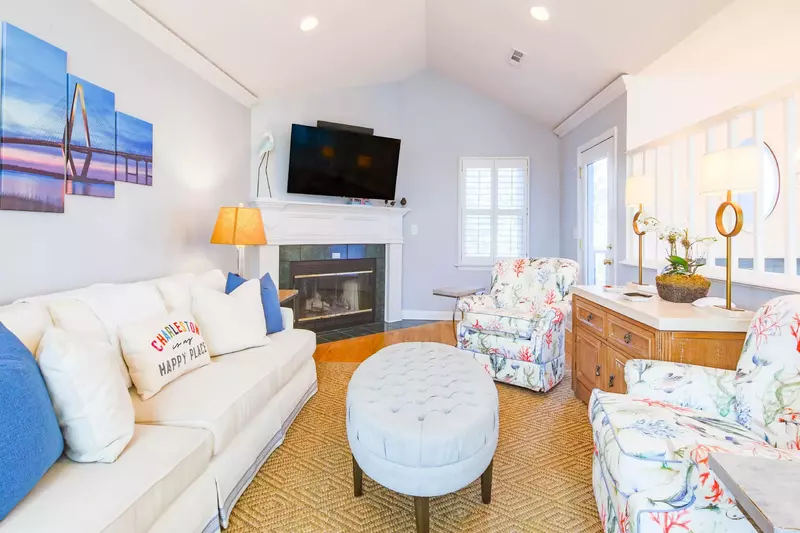 The living room has vaulted ceilings, comfortable furniture and hardwood floors.