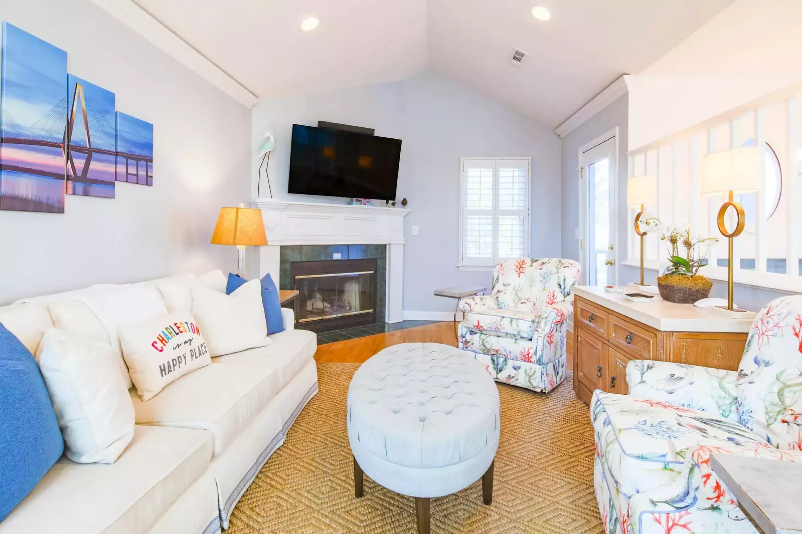 The living room has vaulted ceilings, comfortable furniture and hardwood floors.