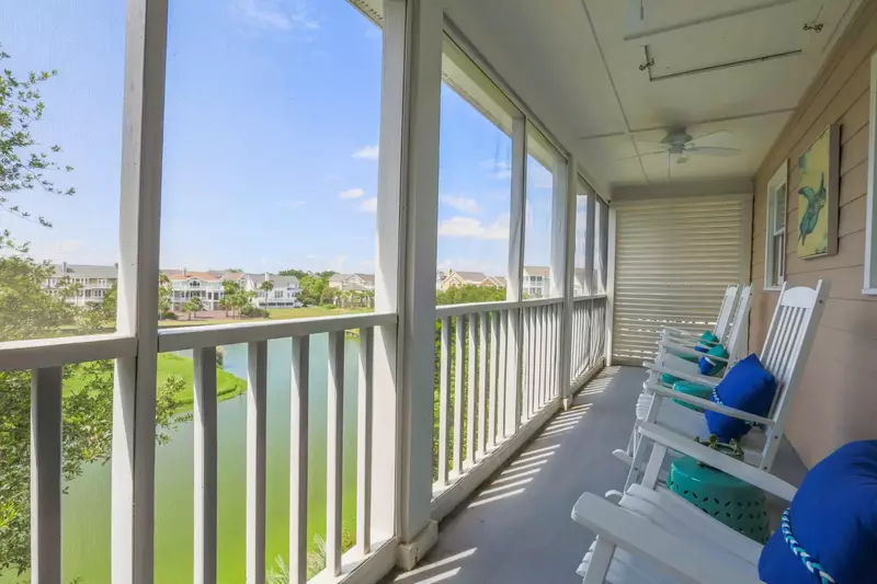This screened porch is located off the living room and overlooks the lagoon and Links Golf Course driving range.