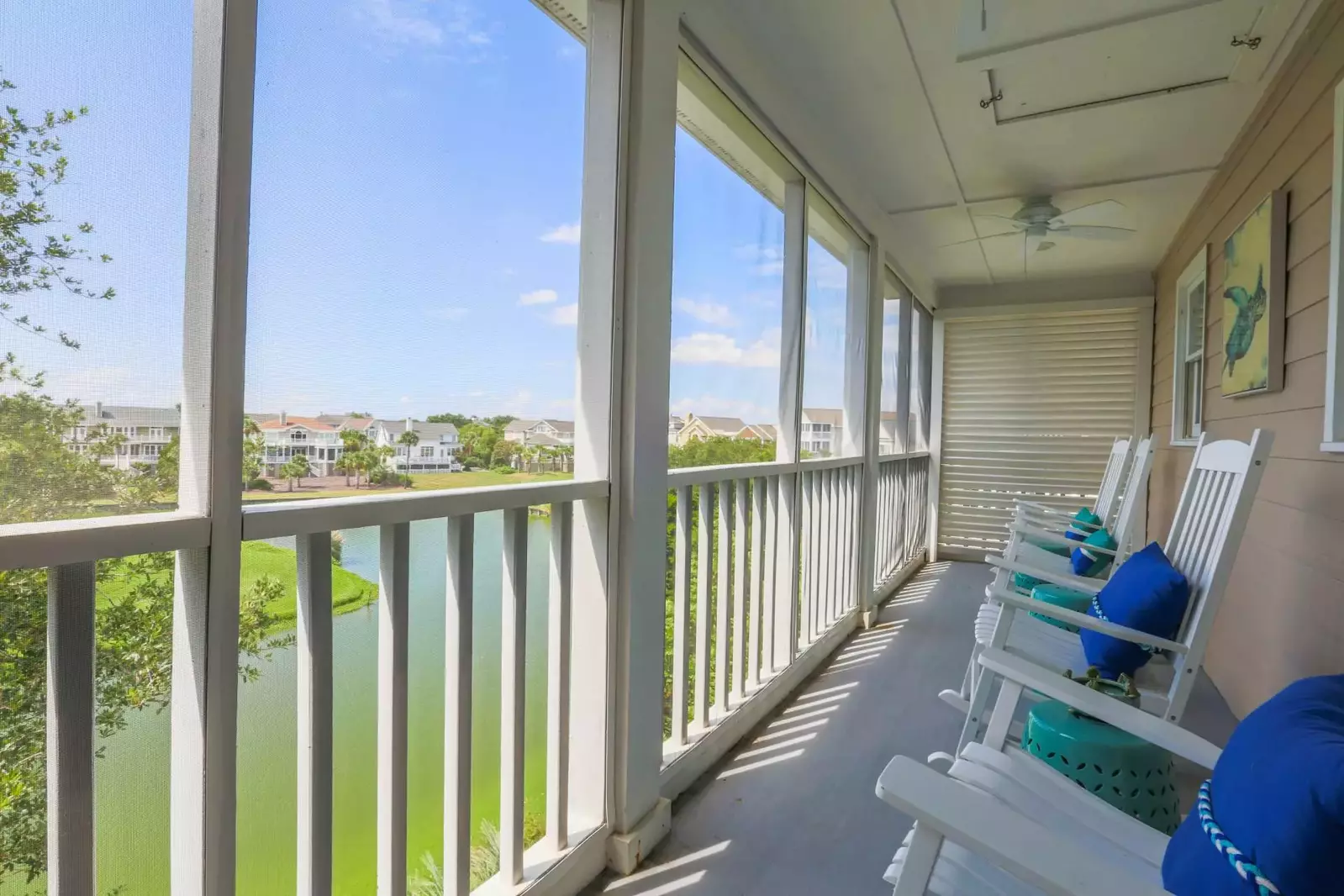 This screened porch is located off the living room and overlooks the lagoon and Links Golf Course driving range.