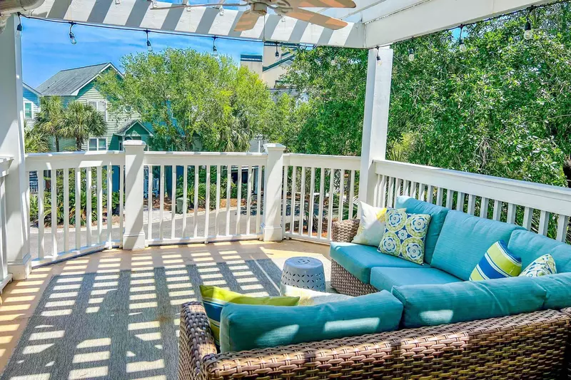 This porch, which is located on the top floor of the house, features a comfortable seating area.