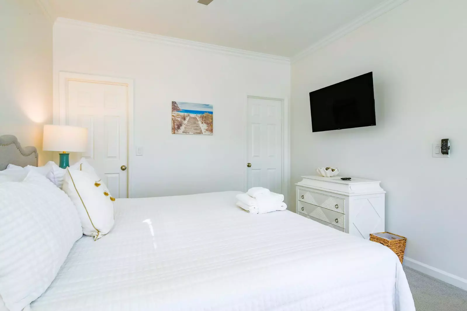 The door on the left leads to a walk-in closet and the door on the right leads to the en suite bathroom.
