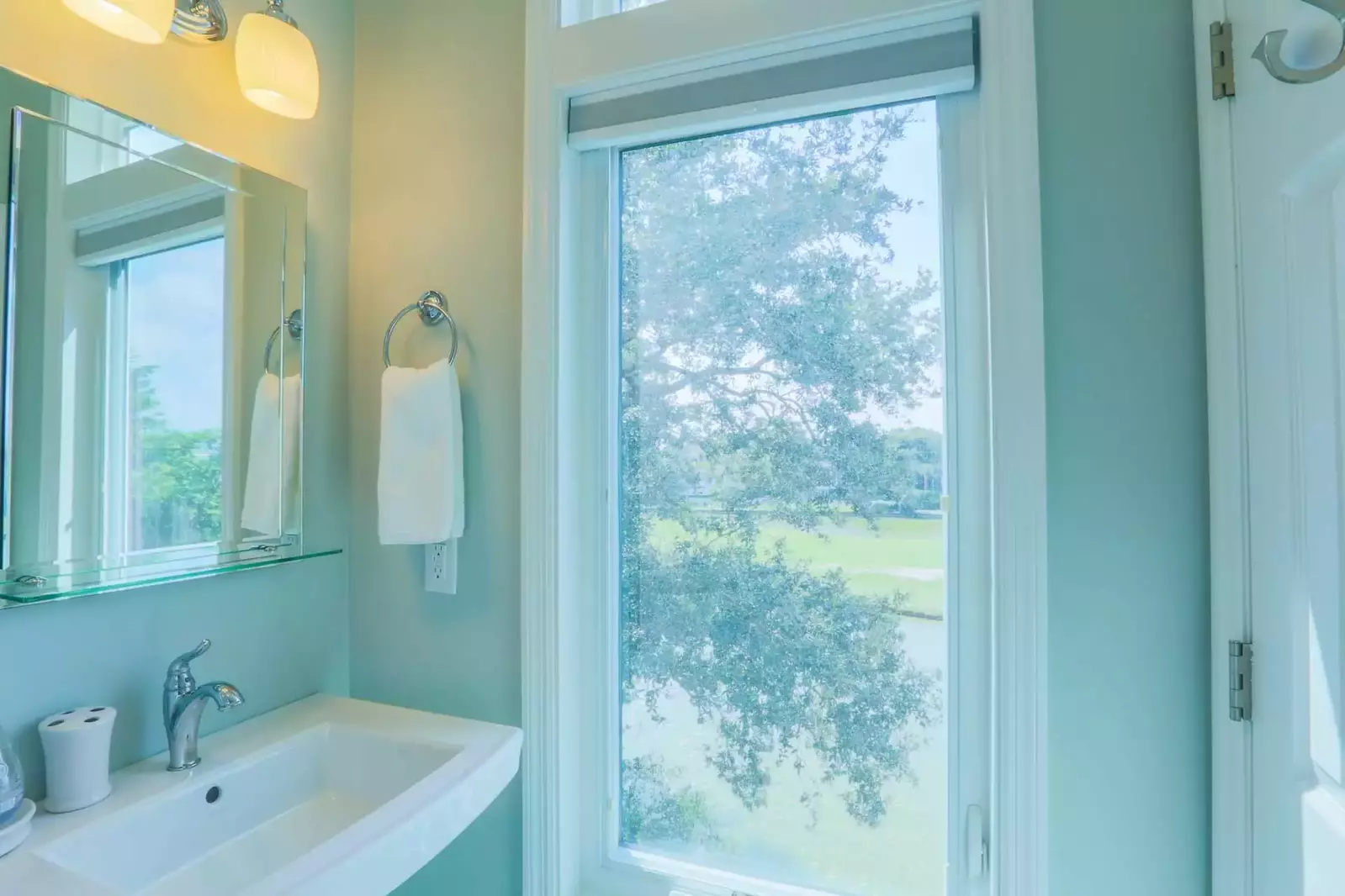 The live oak tree outside the back of the home shapes the views from this bathroom window.