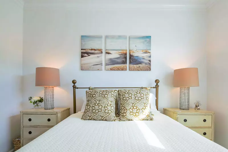 The third bedroom on the home's second floor also features a queen bed with nightstands & reading lamps.