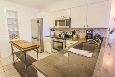 The renovated kitchen is fully stocked for your stay.