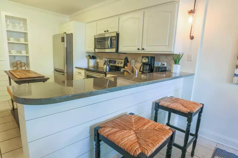 The kitchen features stainless steel appliances and beautiful countertops.