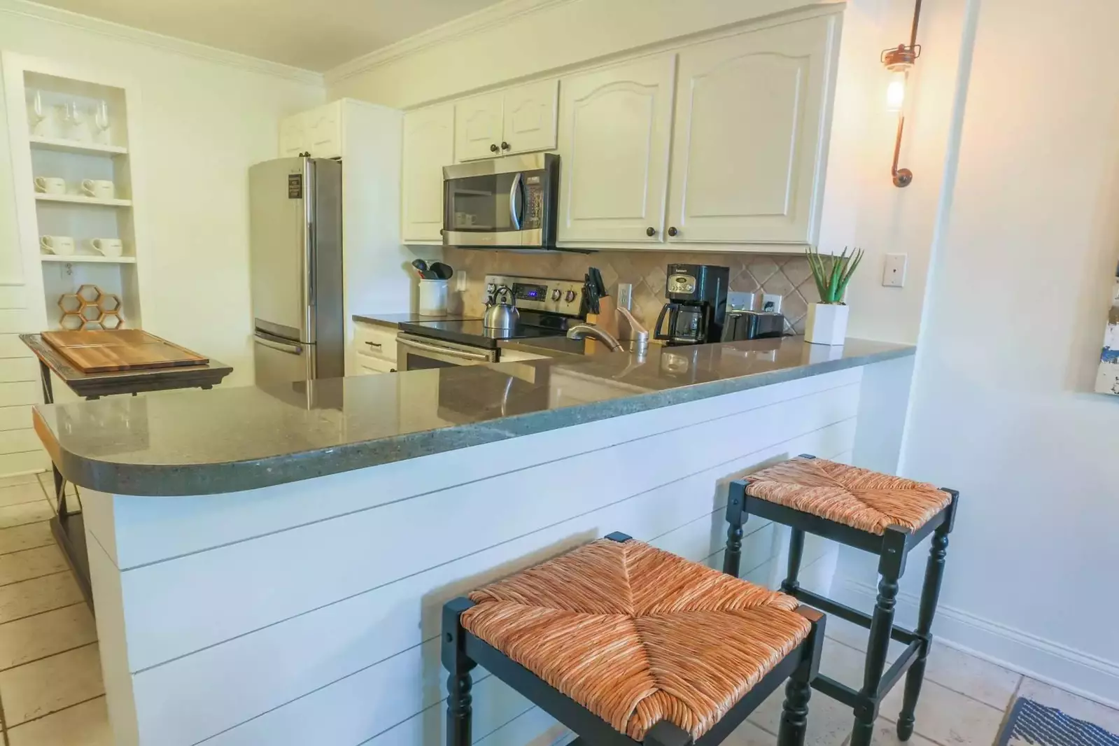 The kitchen features stainless steel appliances and beautiful countertops.