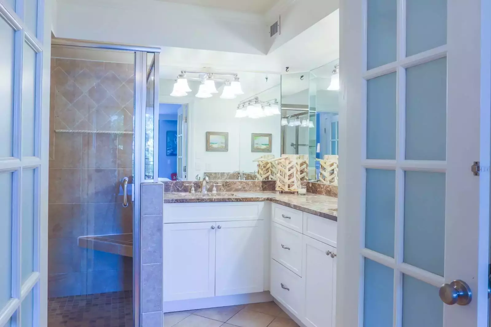 The en suite master bathroom features tiled floors, his & her sinks and a spacious vanity.