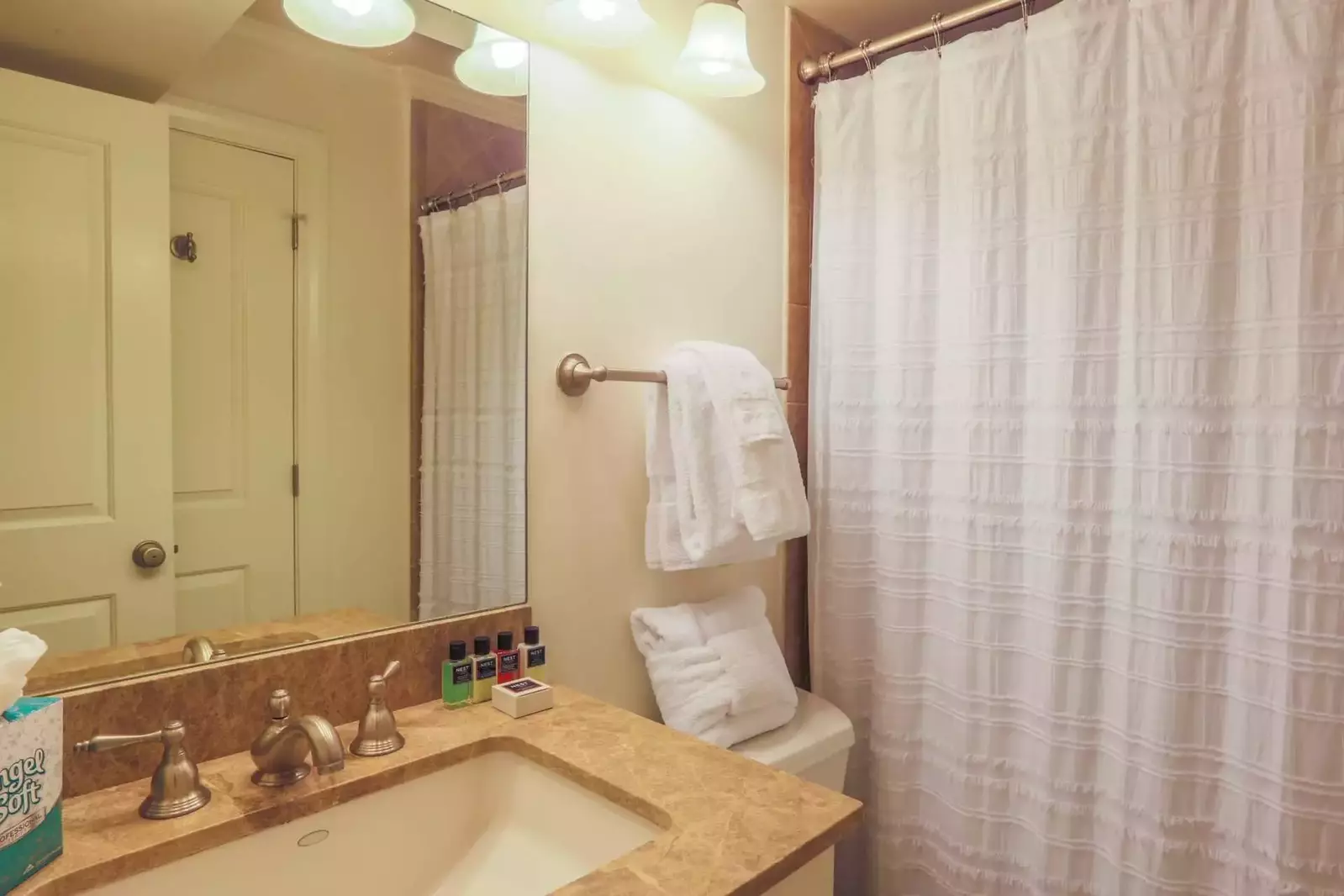 This guest bathroom has a shower/tub combo and spacious vanity.