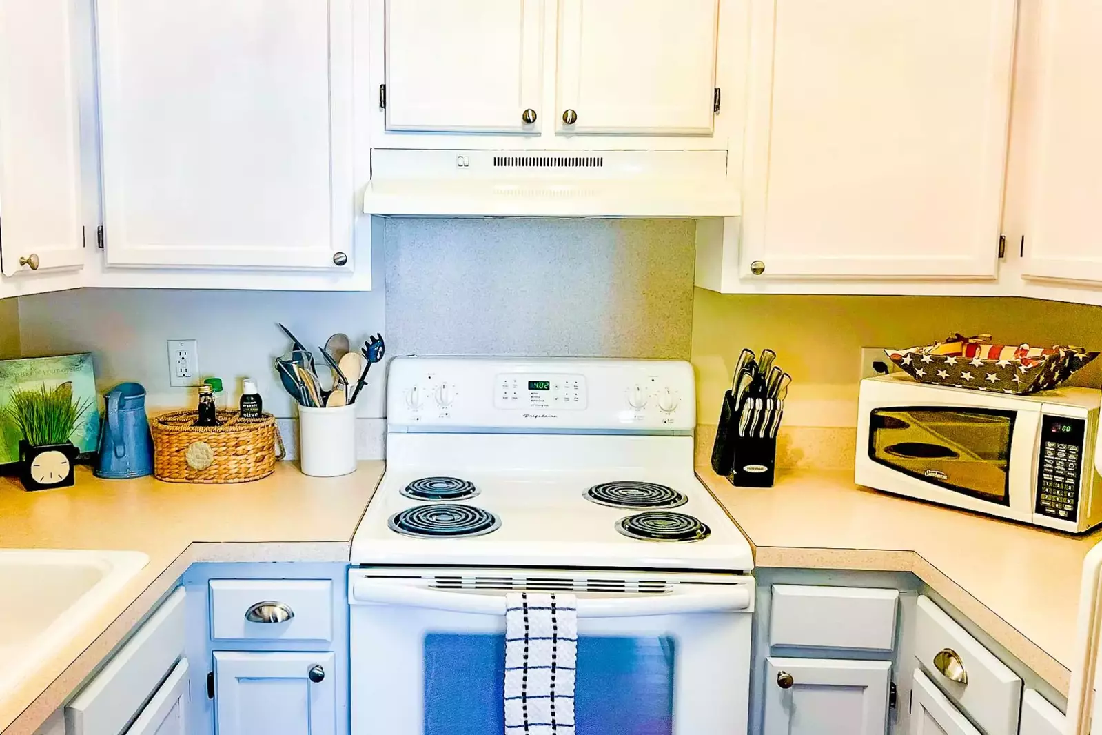 The kitchen features a range, microwave, drip coffee maker and keurig coffee maker.