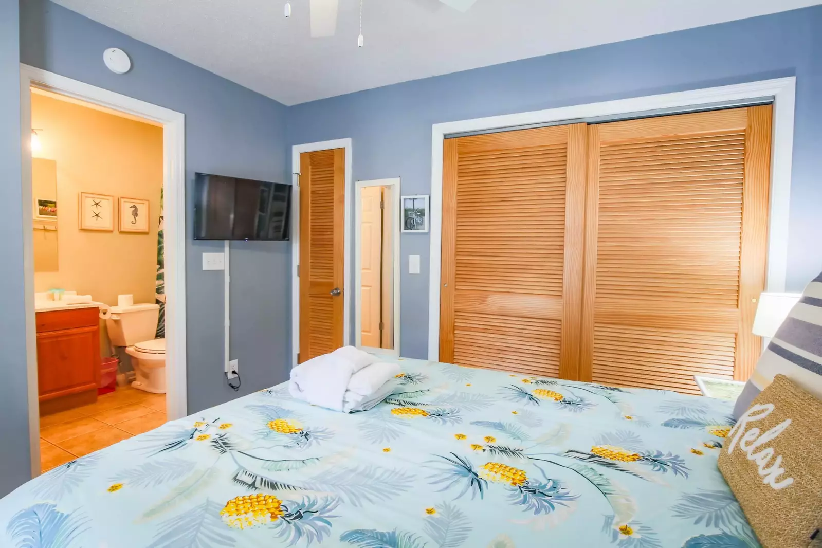 This suite features a mounted streaming TV and an en suite bathroom.