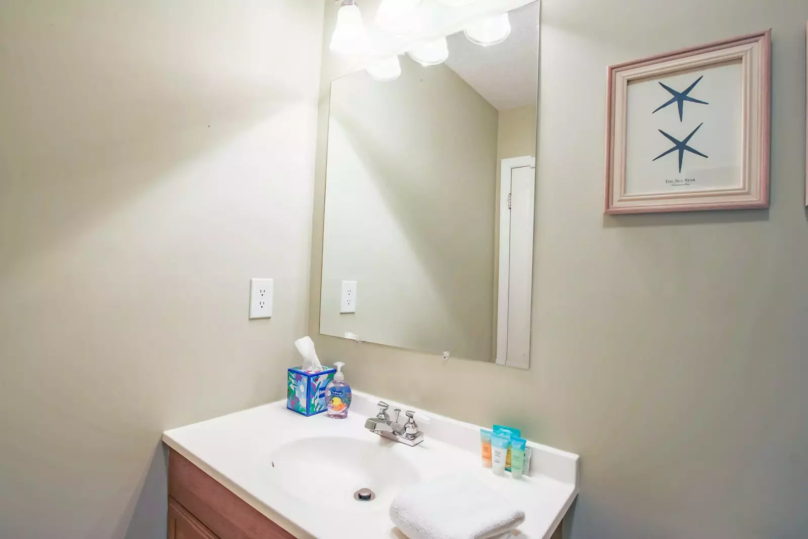 This en suite bathroom features a spacious vanity.