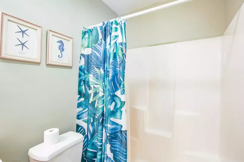 This en suite bathroom also also has a shower/tub combo.
