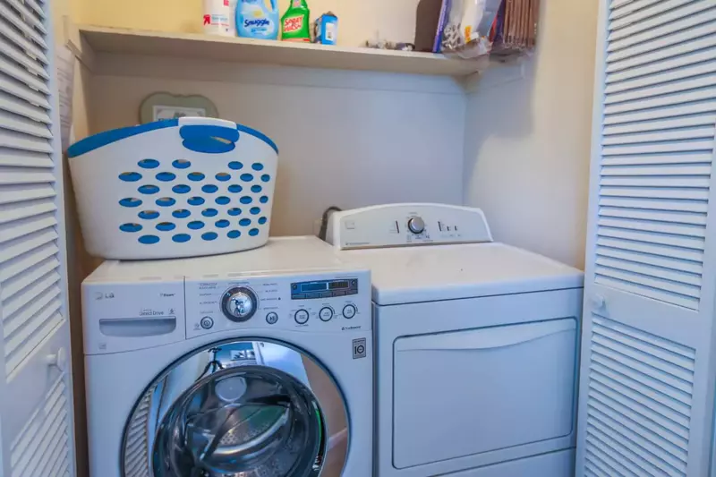 There is a full size washing machine and dryer at the top of the stairs on the second floor.