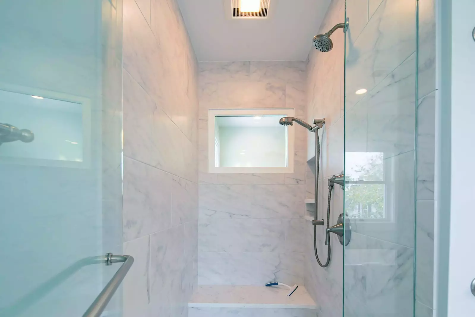 The en suite bathroom also features a tiled, walk-in shower.